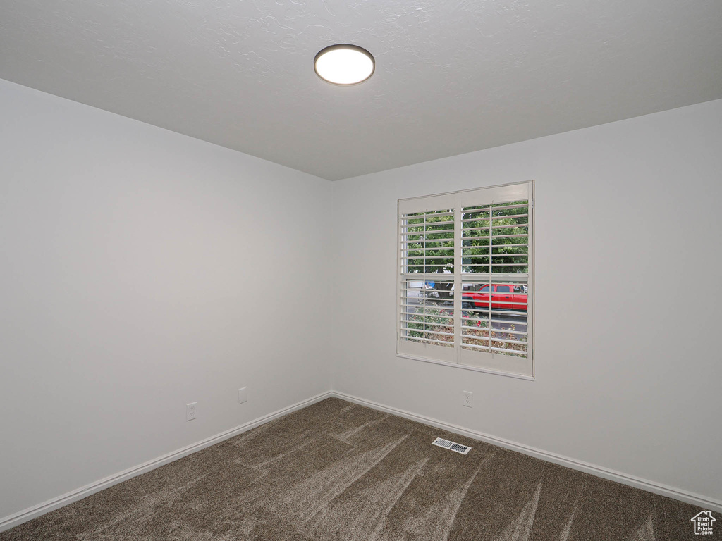 Empty room with dark colored carpet