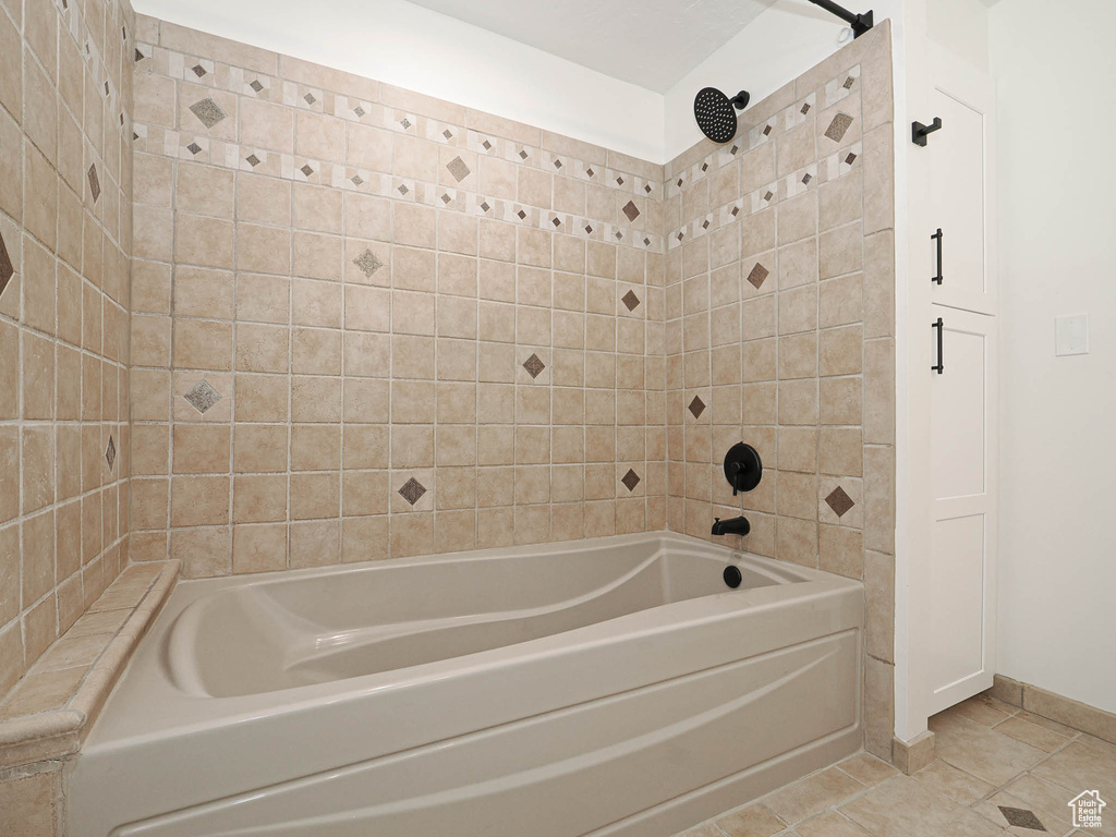 Bathroom with tile patterned flooring and tiled shower / bath combo