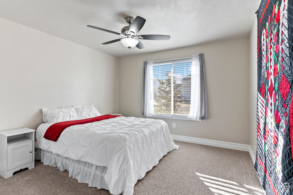 Bedroom with light carpet and ceiling fan