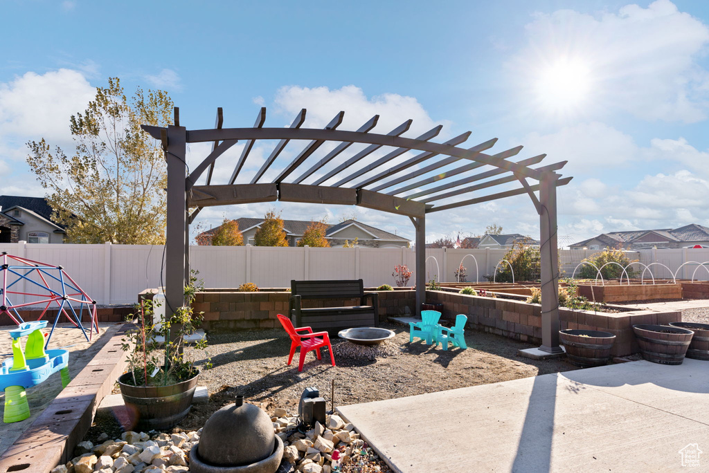 View of yard featuring a patio and a fire pit