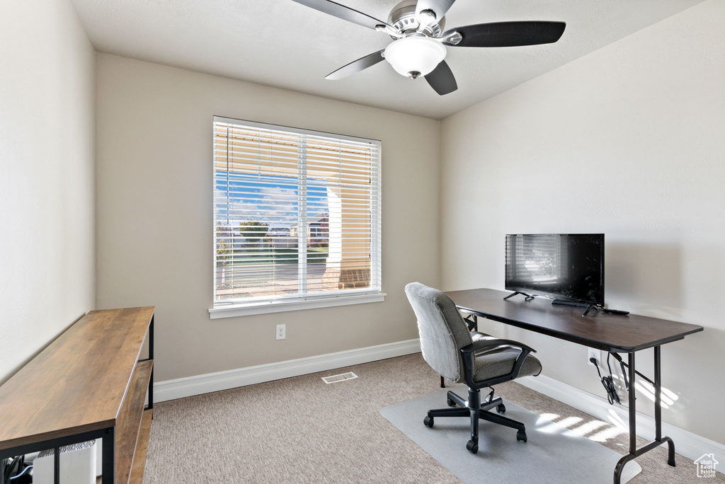 Carpeted office with ceiling fan