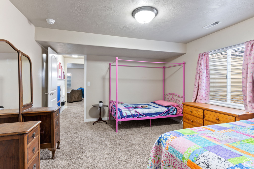 Carpeted bedroom with a textured ceiling