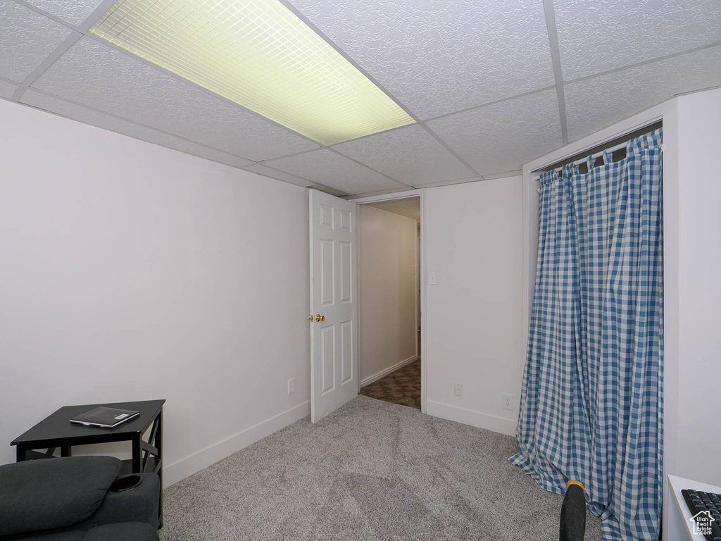 Interior space featuring carpet and a paneled ceiling