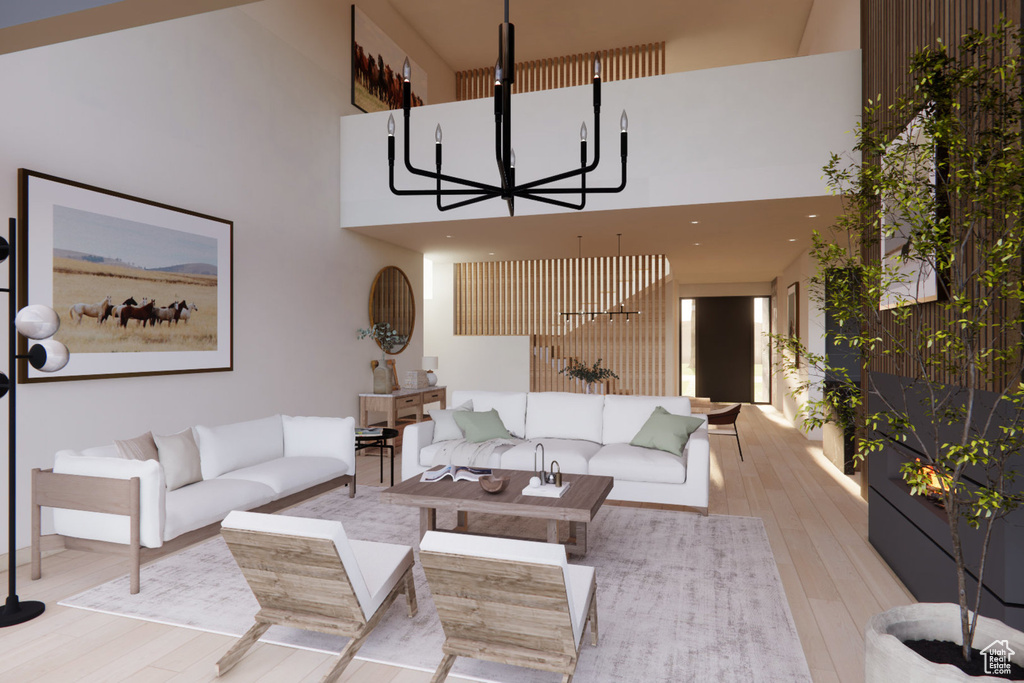 Living room featuring a towering ceiling and light hardwood / wood-style flooring