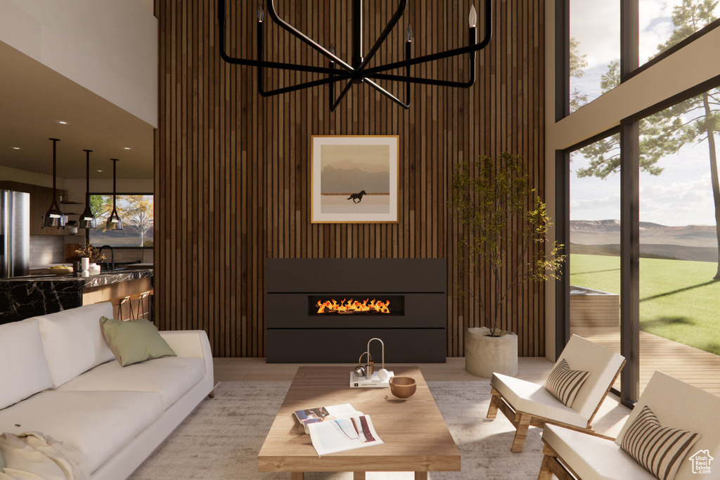 Living room featuring a fireplace, a towering ceiling, and a mountain view