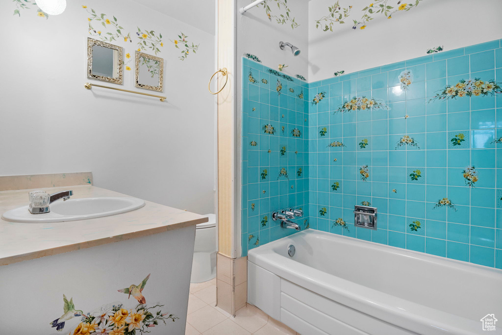 Full bathroom with toilet, vanity, tiled shower / bath, and tile patterned flooring