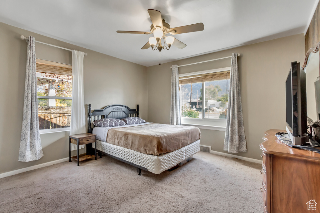 Bedroom with light carpet and ceiling fan