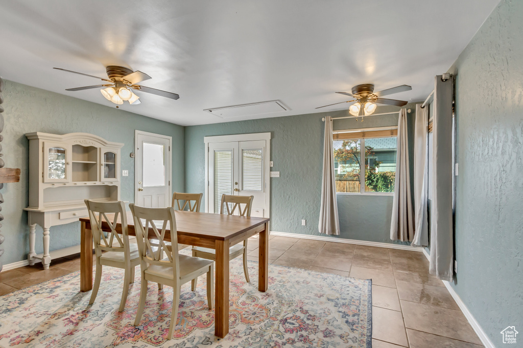 Dining space featuring light tile patterned flooring and ceiling fan