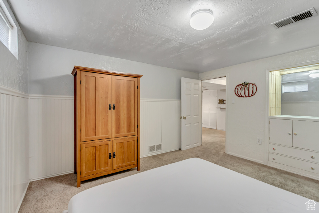 Carpeted bedroom featuring a textured ceiling