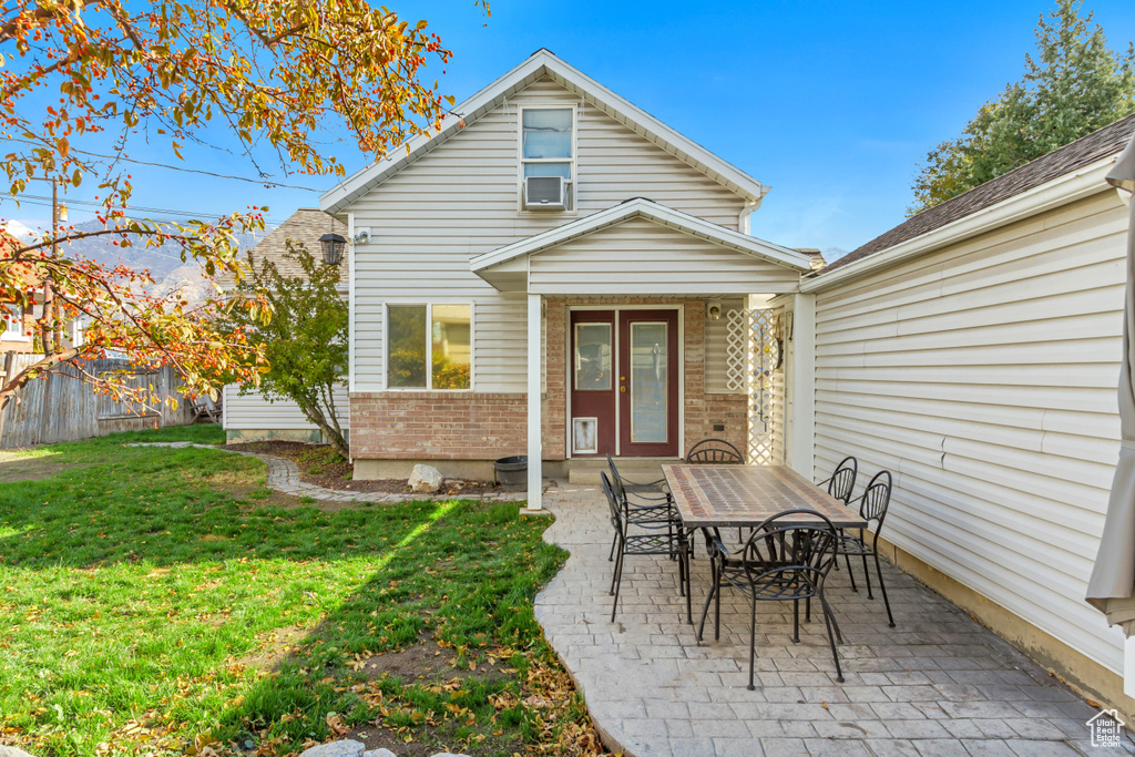 Exterior space with a patio, a lawn, and cooling unit