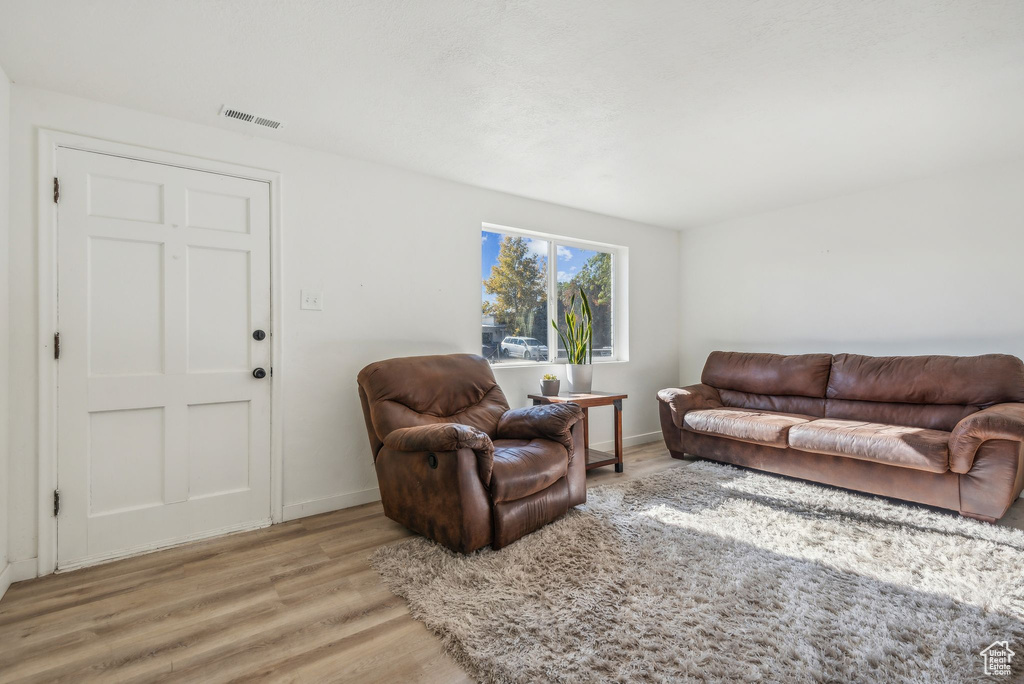 Living room with hardwood / wood-style flooring