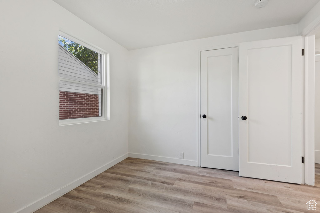 Unfurnished bedroom with light wood-type flooring