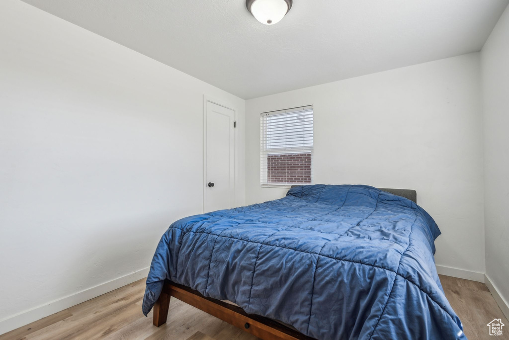 Bedroom with wood-type flooring