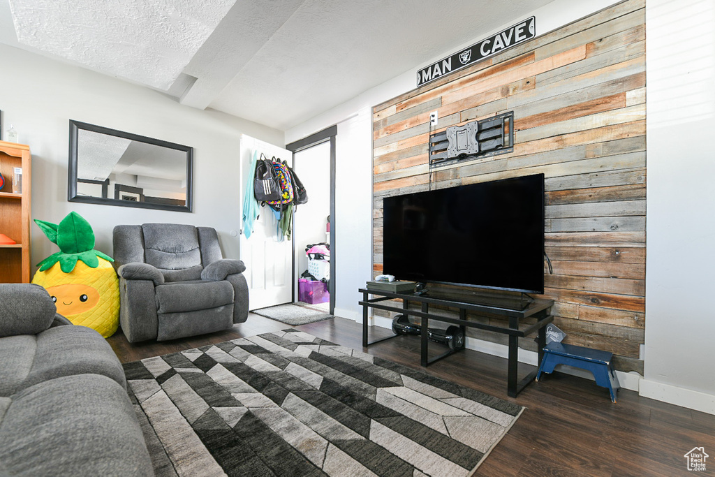 Living room with dark hardwood / wood-style floors and a textured ceiling