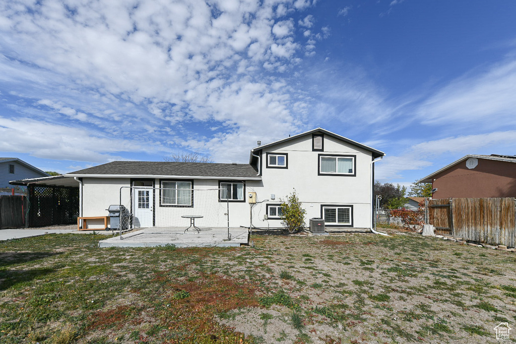 Rear view of house with central air condition unit and a patio