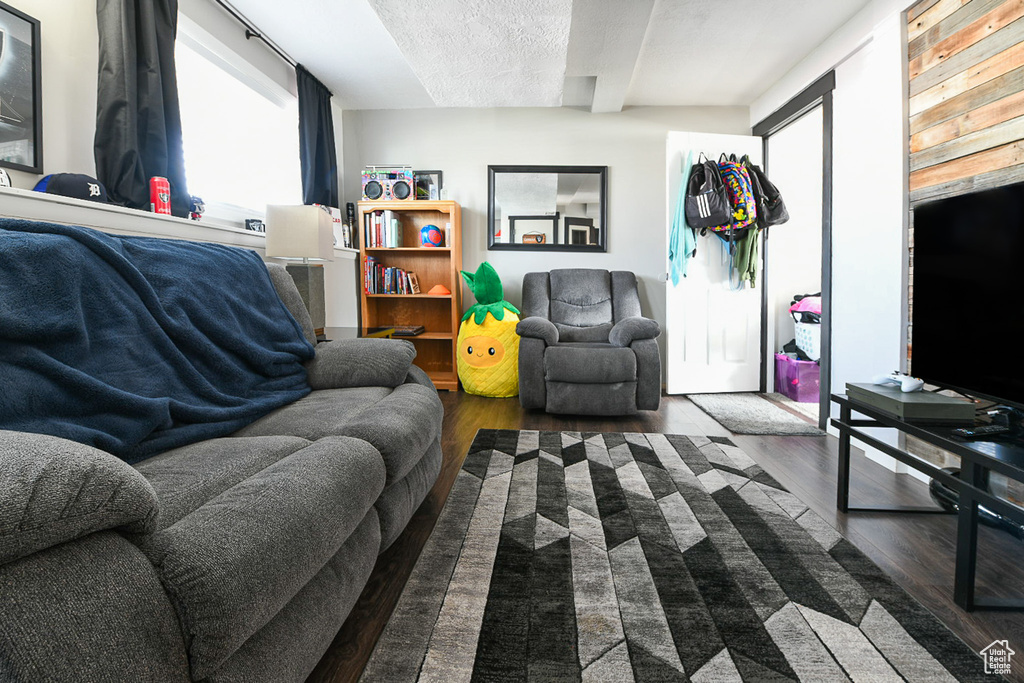 Living room with dark wood-type flooring and a textured ceiling