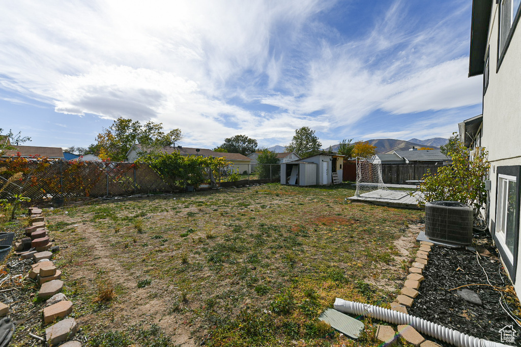 View of yard featuring cooling unit and a mountain view