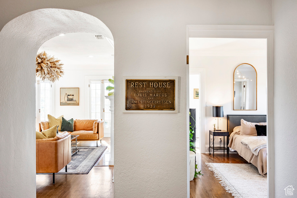 Hall featuring dark hardwood / wood-style flooring and crown molding