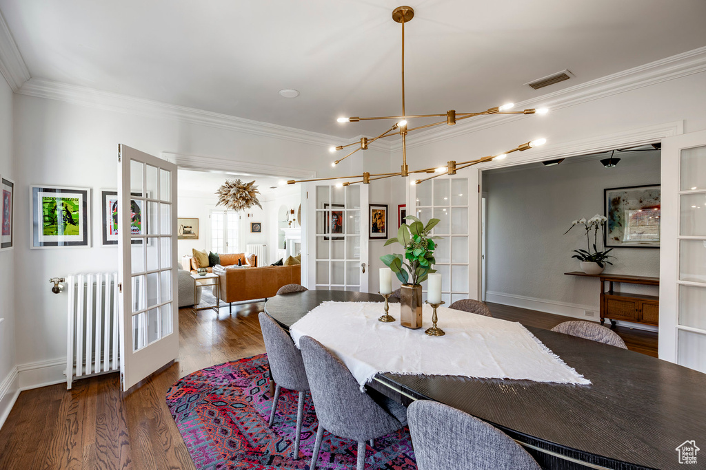 Dining room featuring ornamental molding, french doors, radiator heating unit, and dark hardwood / wood-style floors