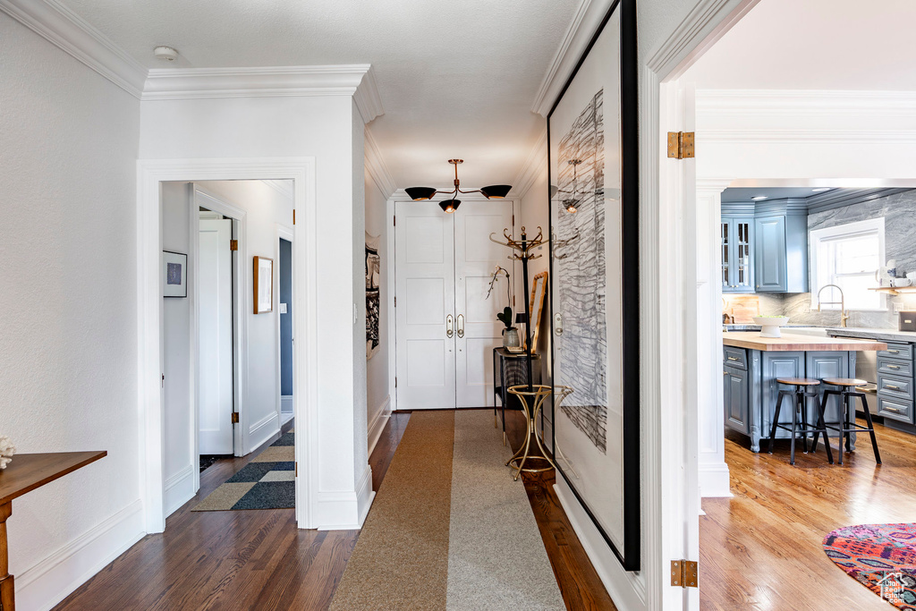 Corridor featuring hardwood / wood-style flooring and ornamental molding