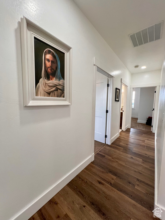 Corridor with dark hardwood / wood-style floors