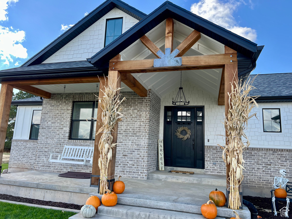 Entrance to property featuring covered porch