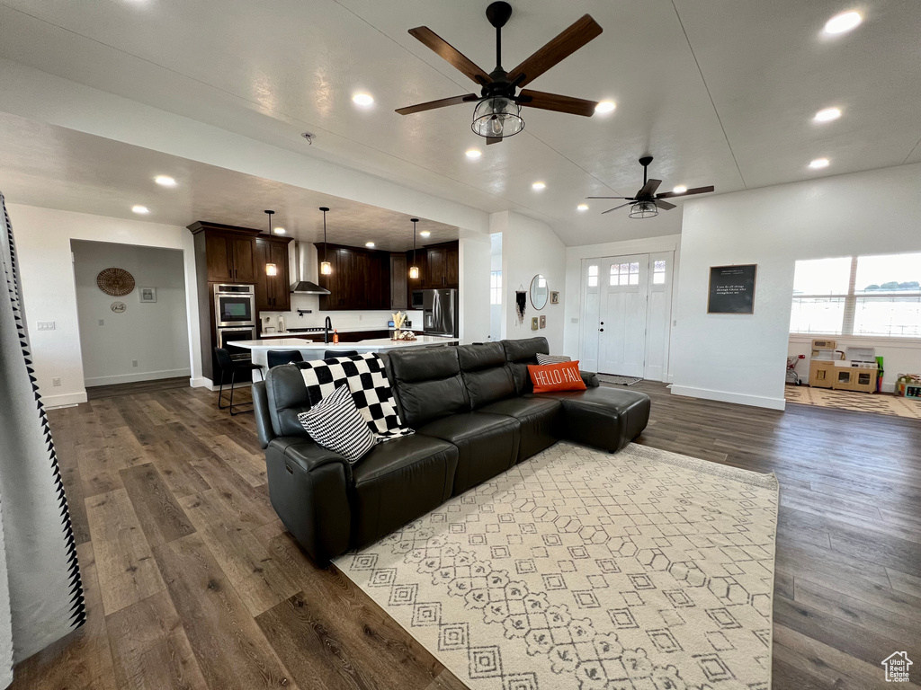 Living room featuring ceiling fan and dark hardwood / wood-style flooring