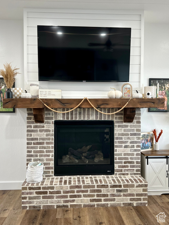 Interior details featuring hardwood / wood-style floors and a brick fireplace