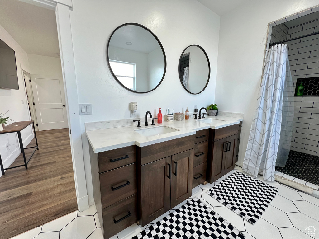 Bathroom with vanity, wood-type flooring, and walk in shower