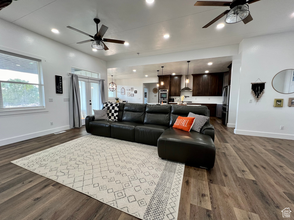 Living room featuring wood-type flooring and ceiling fan