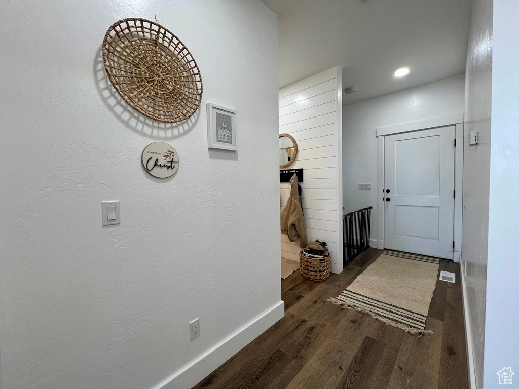 Hallway with dark hardwood / wood-style flooring