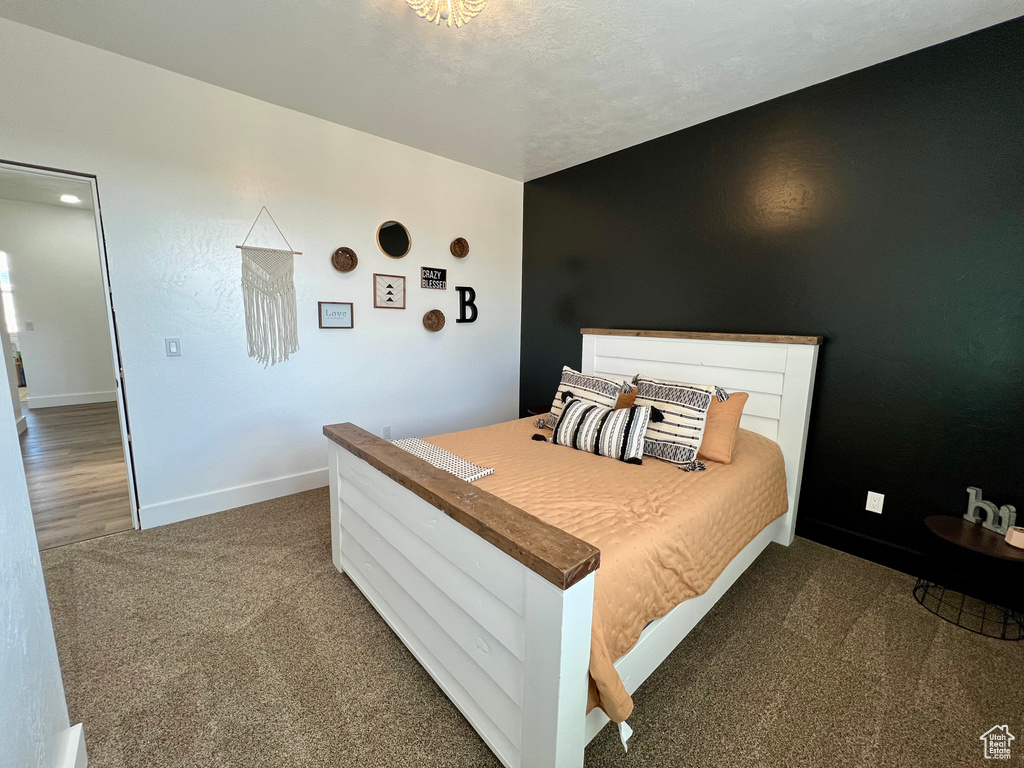 Bedroom featuring dark colored carpet