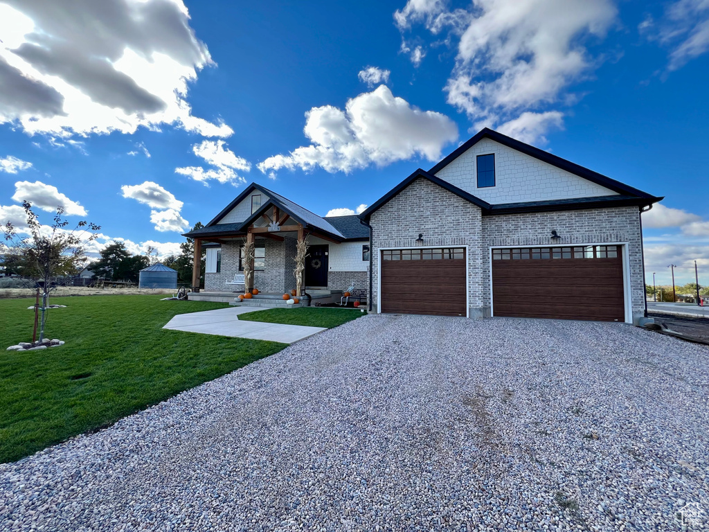 Craftsman house featuring a front yard and a garage