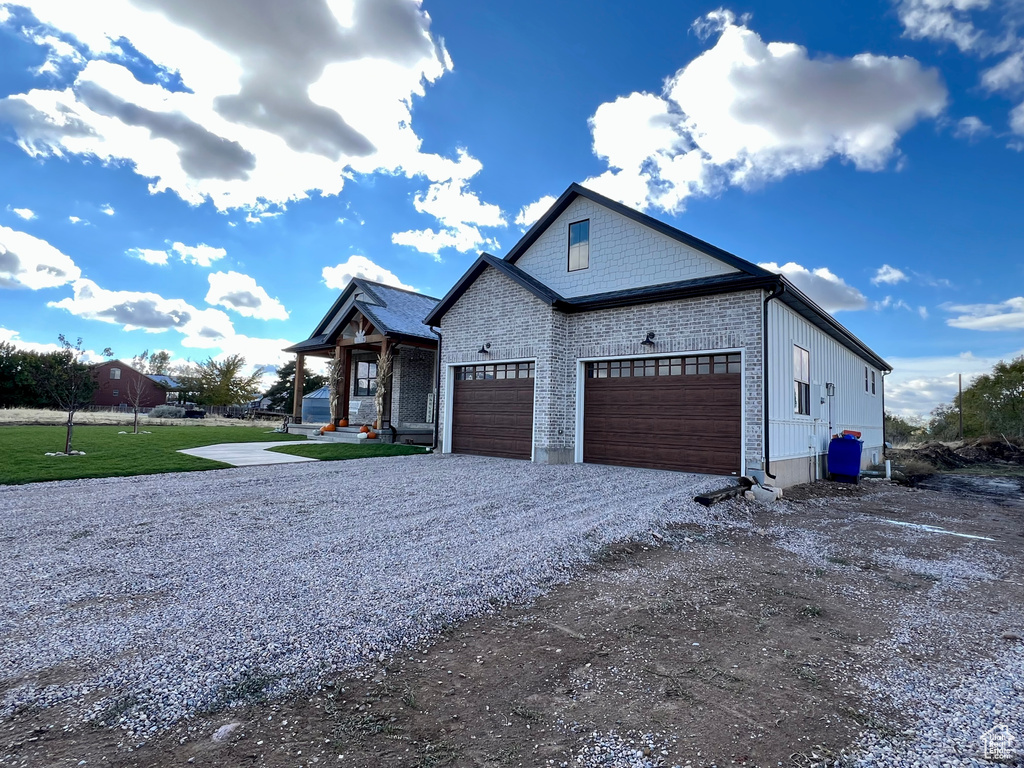 View of front of home with a garage and a front lawn