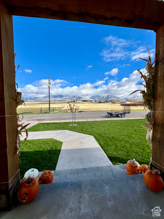 View of yard featuring a mountain view and a patio