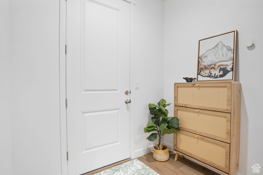 Entryway with hardwood / wood-style flooring and heating unit