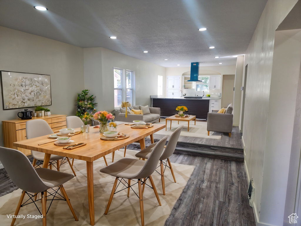 Dining room with wood-type flooring and a textured ceiling