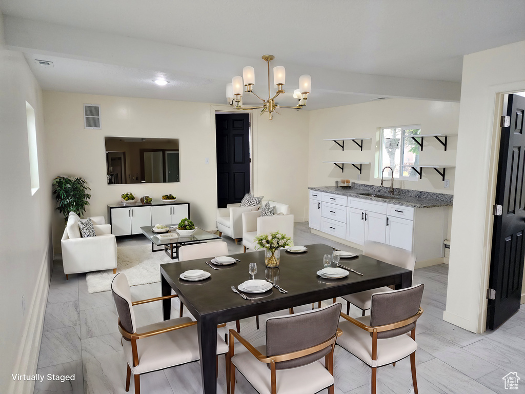 Dining area with a notable chandelier and sink