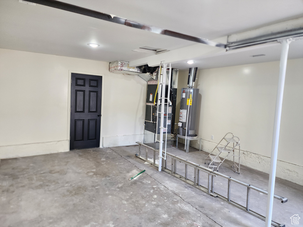 Basement featuring water heater and heating unit