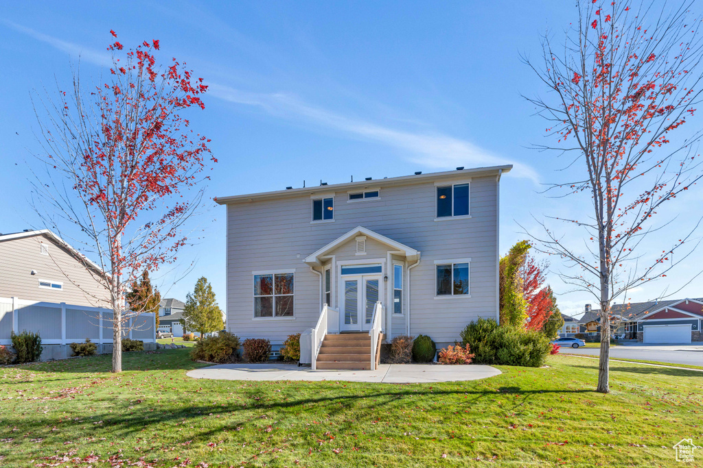 View of front of home with a garage and a front yard