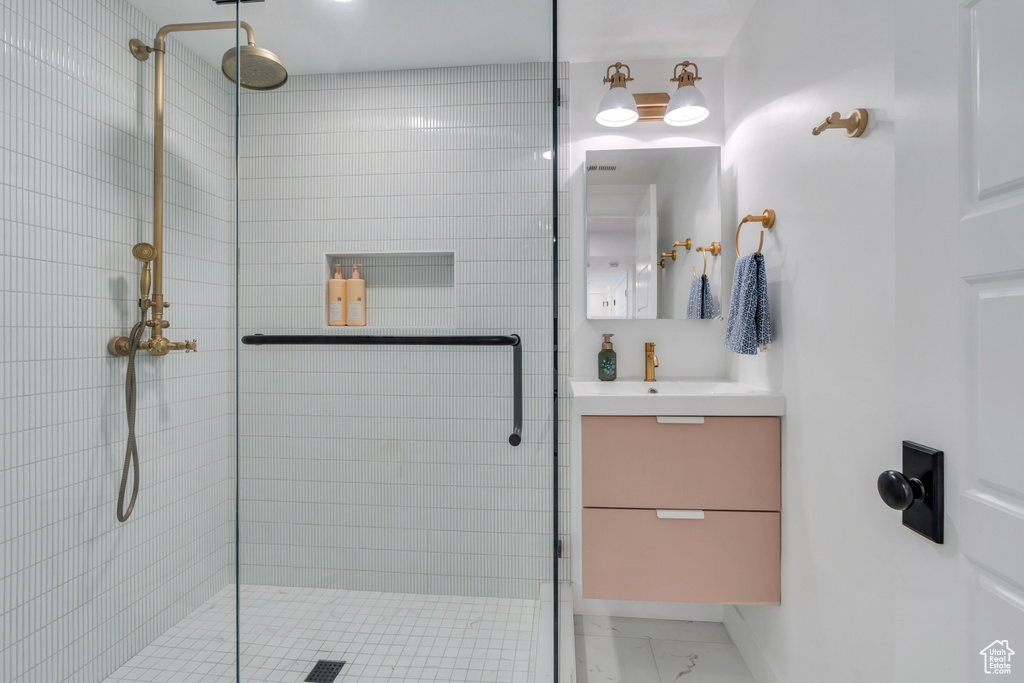 Bathroom featuring vanity and a shower with shower door