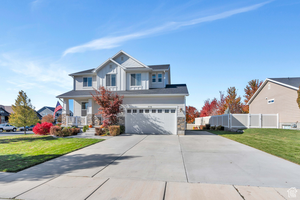 View of front of property with a garage and a front yard