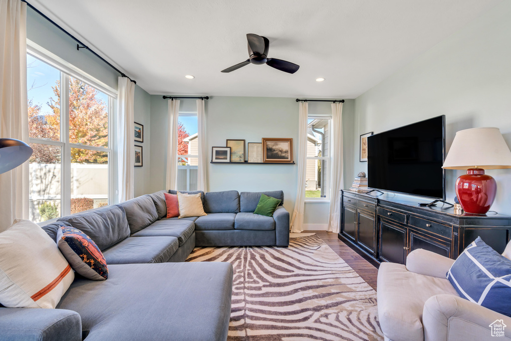 Living room featuring hardwood / wood-style floors and ceiling fan