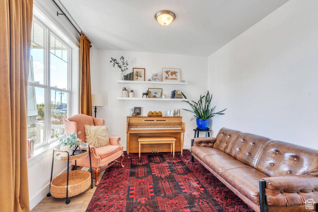 Living area with hardwood / wood-style flooring and a healthy amount of sunlight