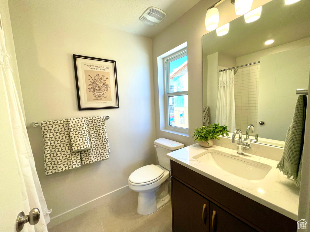 Full bathroom with vanity, tile patterned flooring, and a shower with shower curtain