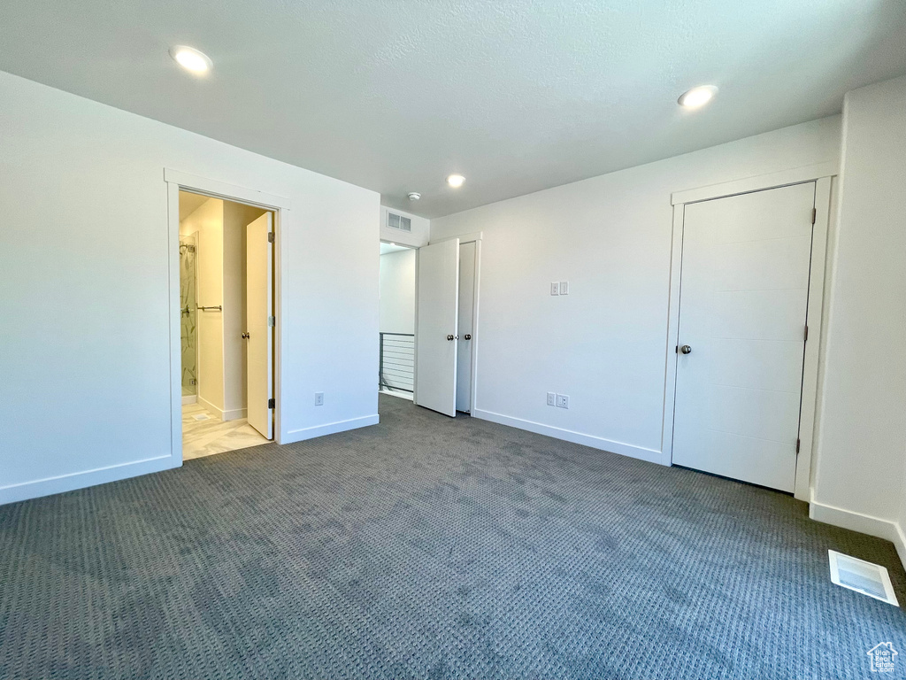 Unfurnished bedroom featuring carpet, recessed lighting, and ensuite bathroom