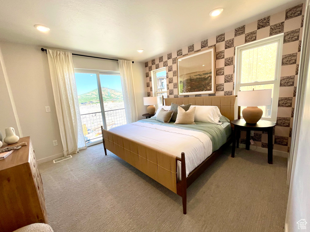 Bedroom with wallpapered walls, access to outside, light carpet, and recessed lighting