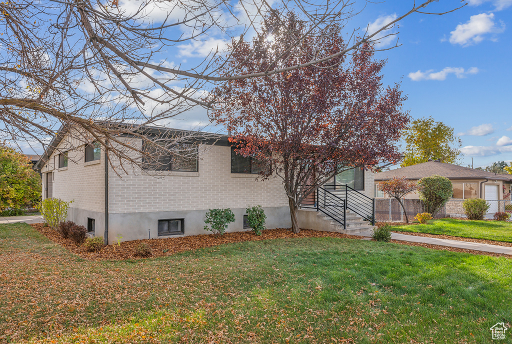 View of property exterior featuring a yard