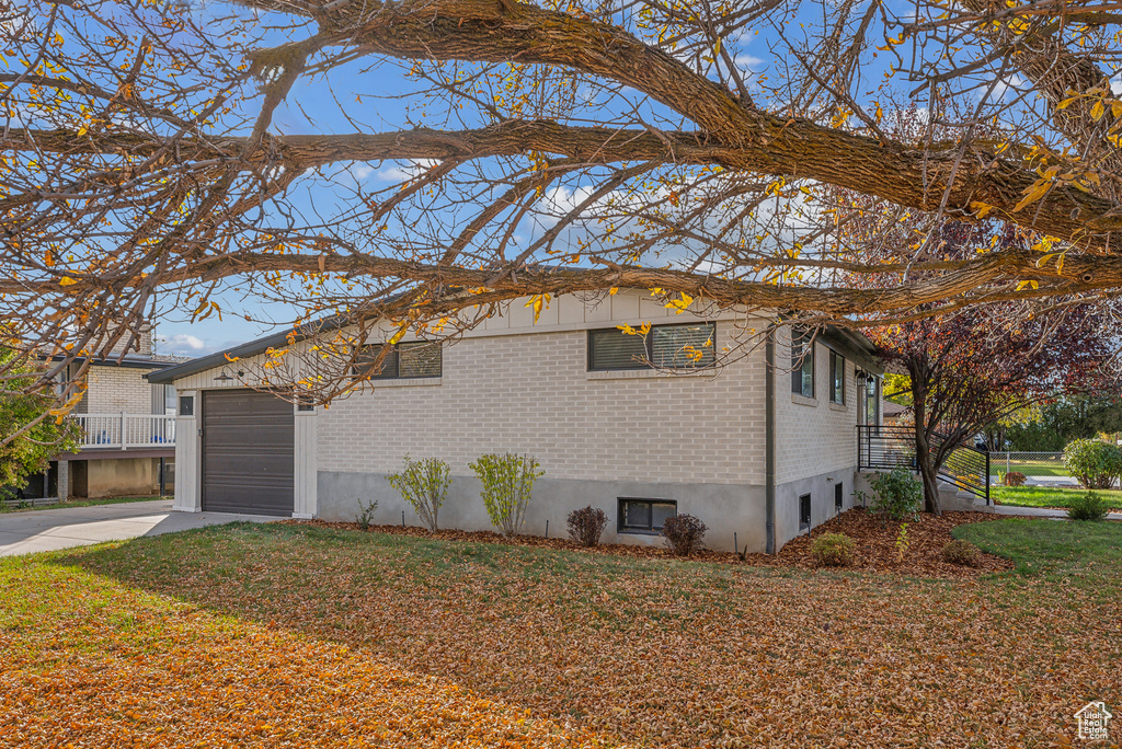 View of front of house featuring a garage and a front lawn