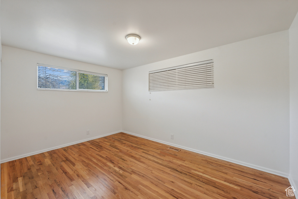 Unfurnished room with hardwood / wood-style floors